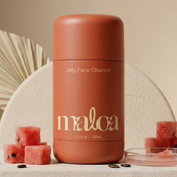 Coral-colored jelly face cleanser bottle with 'maloa' branding on a neutral background.
