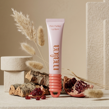 Lip balm tube with decorative elements on a neutral background